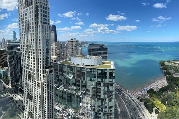 Panoramic view of a cityscape with tall buildings and waterfront.