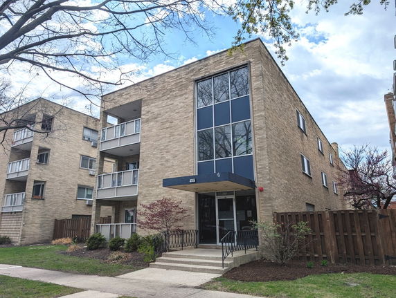 Front view of a three-story apartment building with a modern facade.