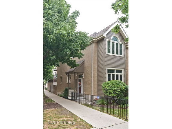 Front view of a two-story house with brick and siding.