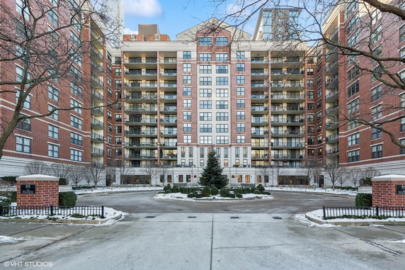 Front view of a multi-story residential building with balconies.
