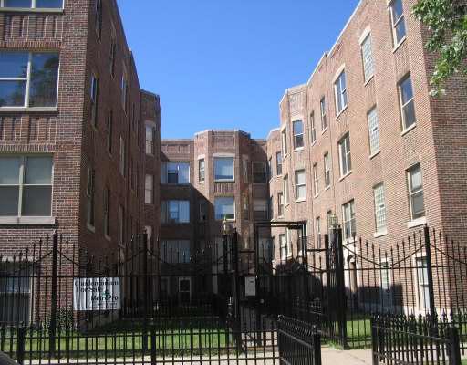 Front view of a multi-story brick apartment building.