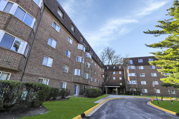 Front view of a multi-story brick apartment building.