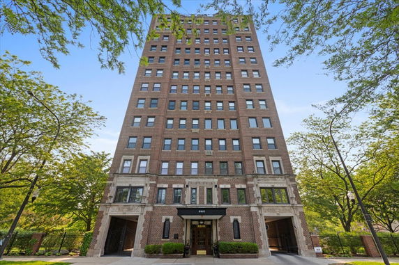 Front view of a multi-story brick apartment building.