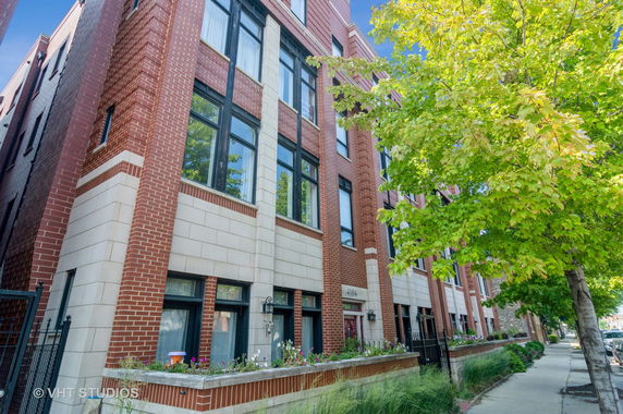 Front view of a multi-story brick residential building.