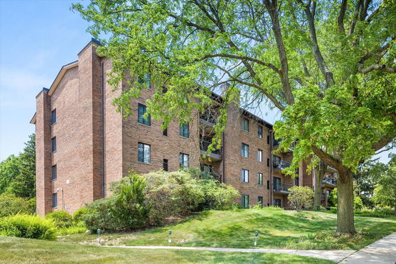 Front view of a multi-story brick apartment building.