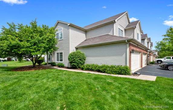 Front view of a two-story house with a garage.