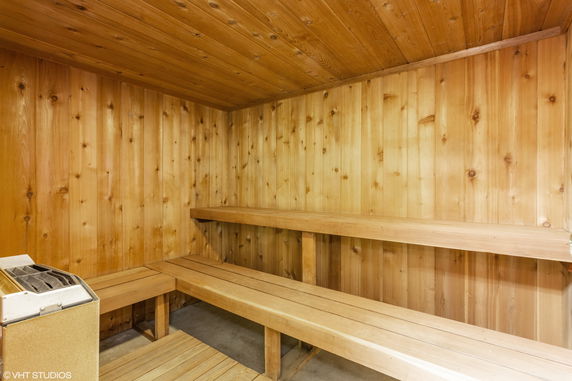 Interior view of a wooden sauna with benches.