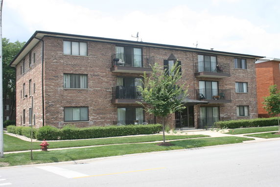 Front view of a three-story brick apartment building.