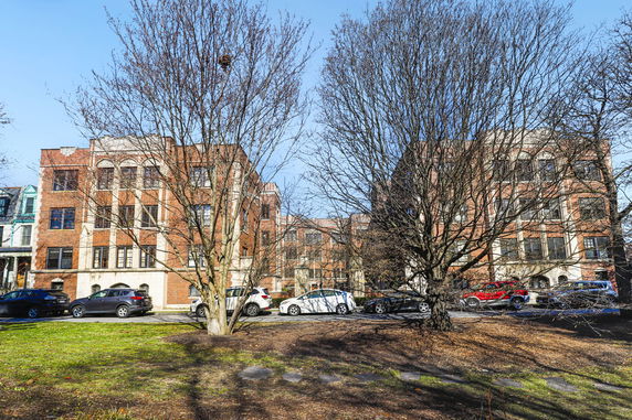 Front view of multi-story brick buildings.