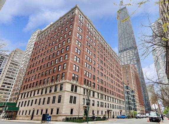 Front view of a multi-story brick building in an urban setting.