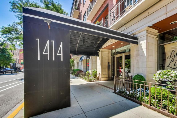 Front view of a building entrance with a canopy and street number 1414.