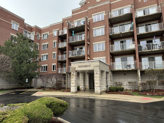 Front view of a multi-story apartment building with balconies