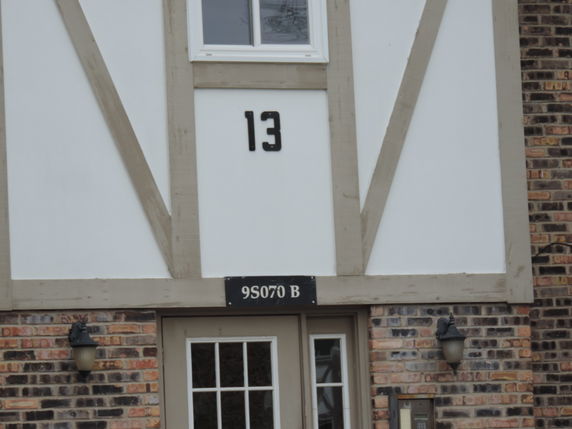 Front view of a two-story building with number 13 above the entrance.
