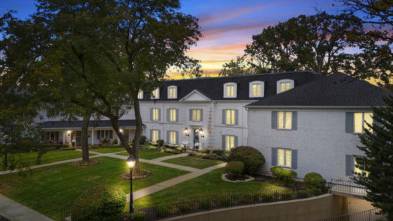 Front view of a large, multi-story building with dormer windows.
