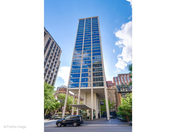 Front view of a modern high-rise building with a glass facade.