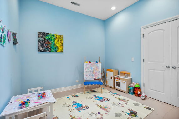 Children's play area with toys and art supplies.