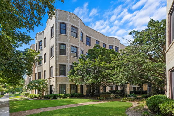 Front view of a multi-story building with a brick facade.