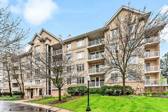 Front view of a multi-story residential building with balconies.