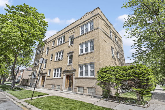 Front view of a three-story brick apartment building.