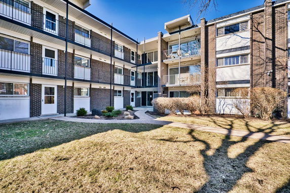 Front view of a multi-story residential building with balconies.