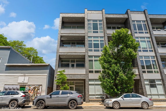 Front view of a multi-story apartment building with modern design.