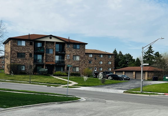 Front view of a three-story brick apartment building.