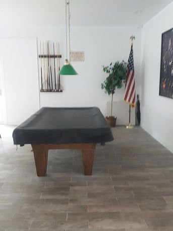 Indoor room with a pool table and American flag.