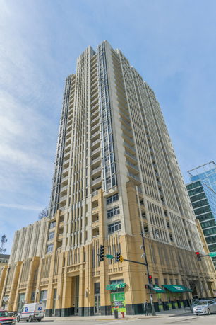 Front view of a tall, multi-story building with a modern architectural design.