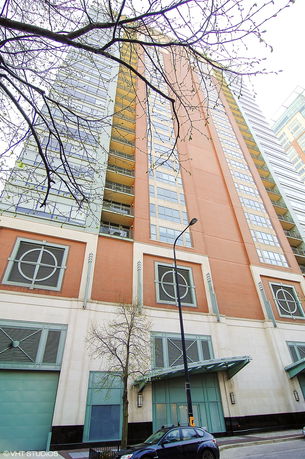 Front view of a tall multi-story building with a modern facade and balconies.