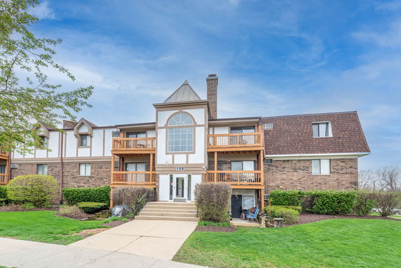 Front view of a multi-story residential building with balconies.