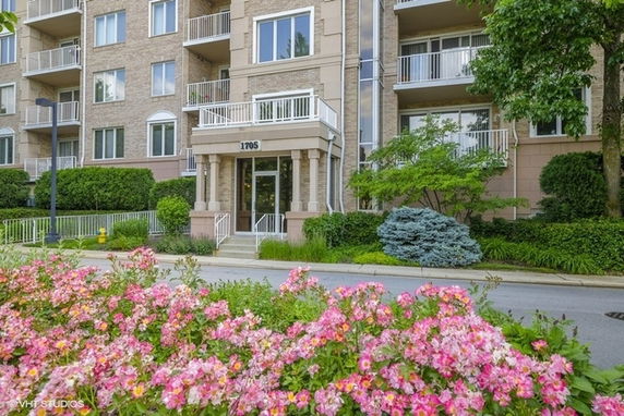 Front view of a multi-story residential building with balconies.