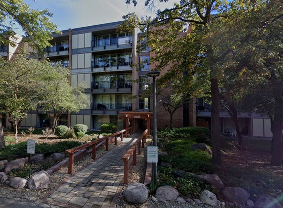 Front view of a multi-story residential building with balconies.