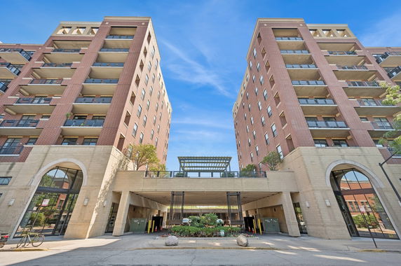 Front view of a multi-story building with two connected towers.