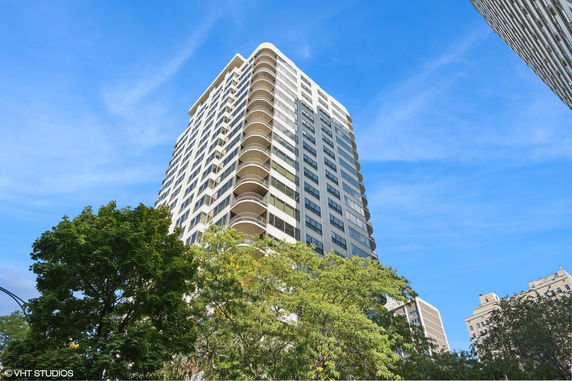 Front view of a multi-story residential building with balconies.