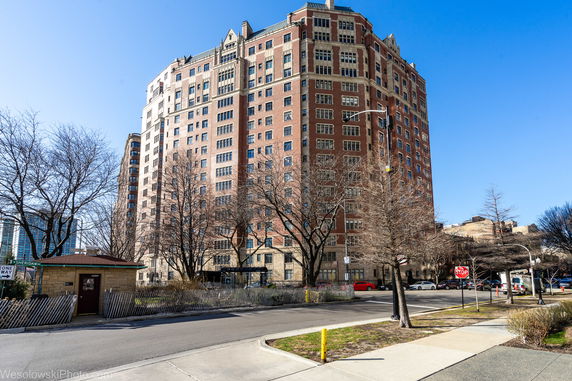 Front view of a multi-story building with a brick facade.