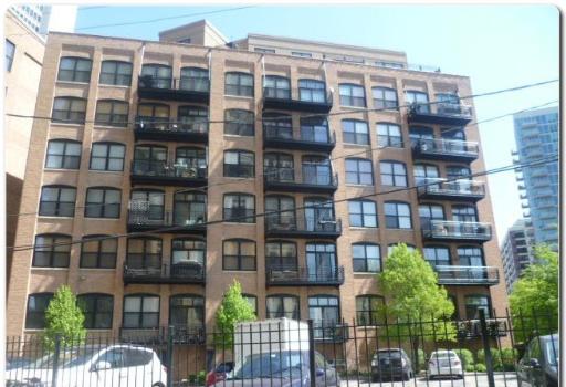Front view of a multi-story apartment building with balconies.
