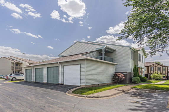 Front view of a two-story residential building with multiple garages.