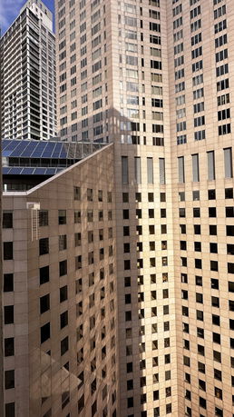 Front view of a tall building with numerous windows and a modern design.