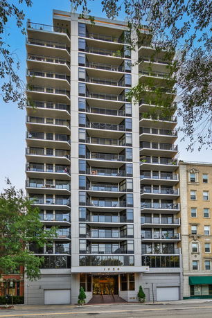 Front view of a multi-story residential building with balconies.