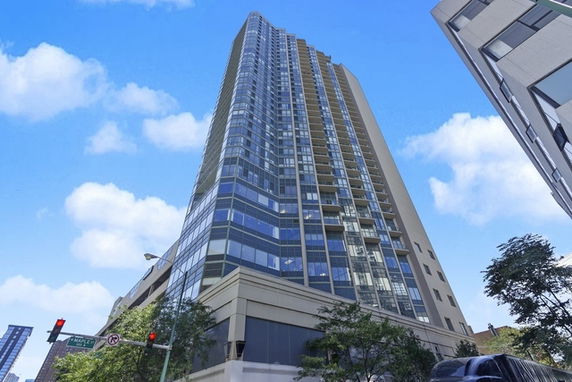Tall modern skyscraper with numerous floors and glass windows.