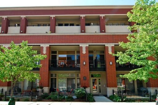 Front view of a multi-story building with balconies.