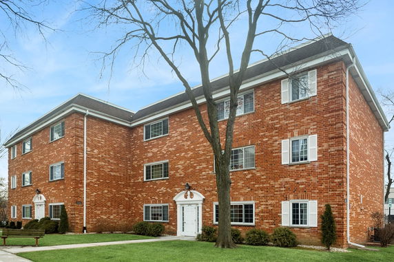 Front view of a three-story brick apartment building.