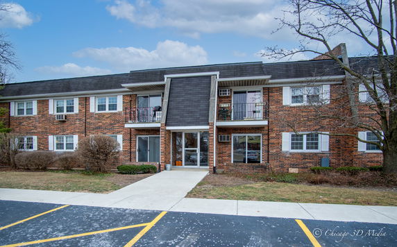 Front view of a two-story brick apartment building.