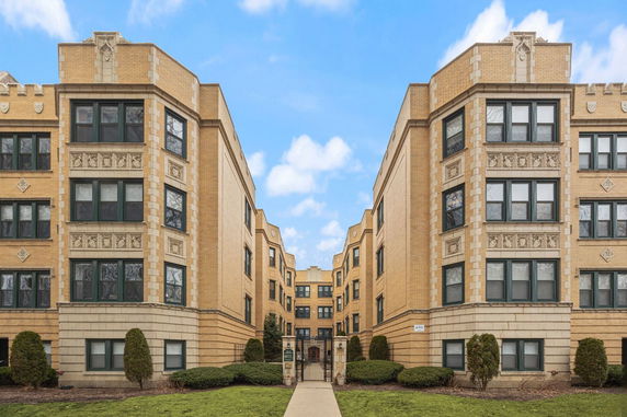 Front view of a multi-story brick apartment building.