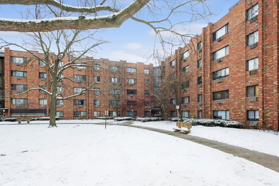 View of a multi-story brick apartment building in winter.