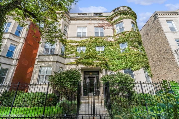 Front view of a multi-story building with ivy-covered facade.