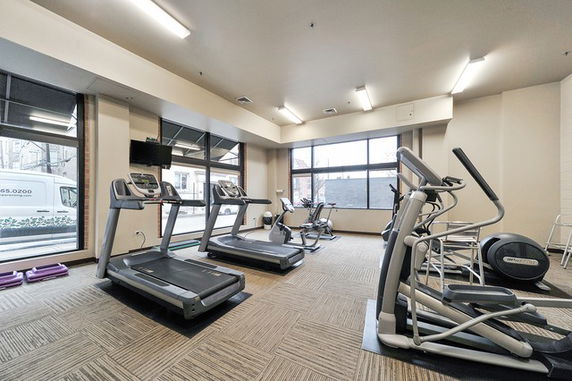 Interior view of a gym area with treadmills and exercise equipment.
