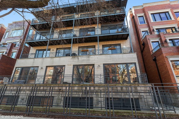 Front view of a multi-story building with balconies.