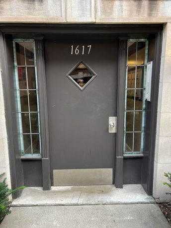 Front view of a building entrance with a door numbered 1617.