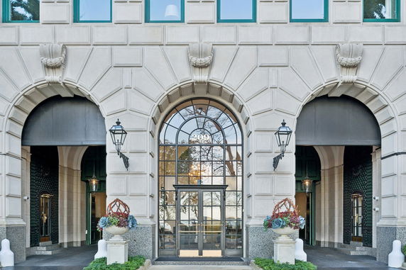 Front view of a building with arched windows and entryway.